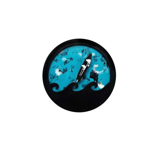 Horloge des marées bleu, ronde avec une vague noir en surimpression
