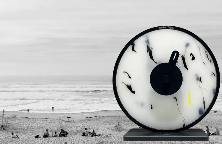 horloge des marées blanche et noire avec un arrière plan de plage